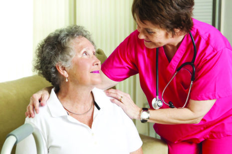 a nurse assisting an elderly