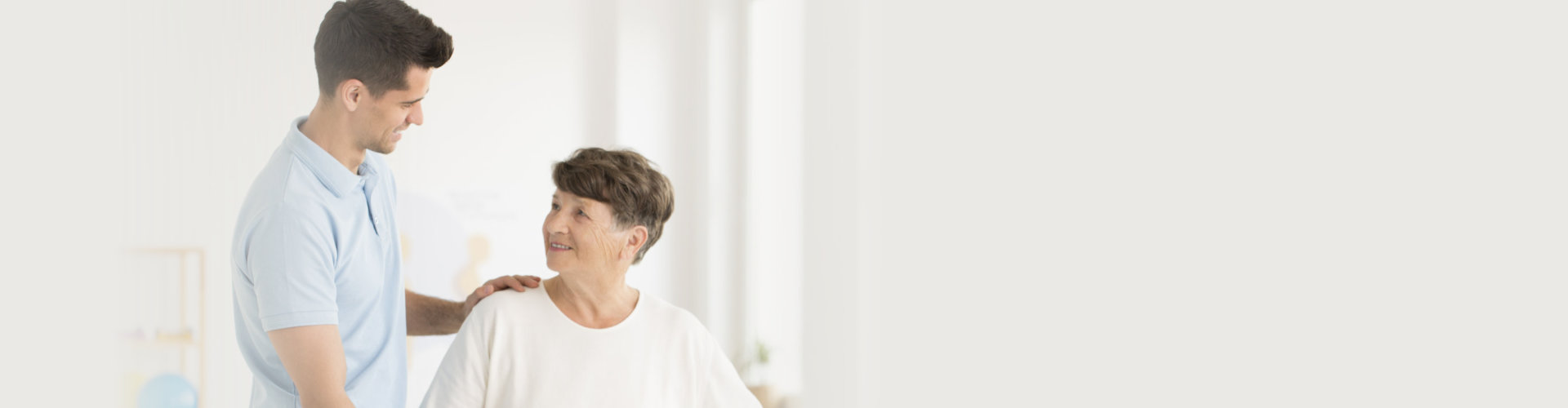 male caregiver talking to senior woman